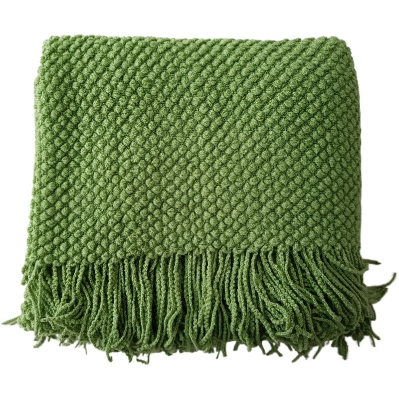 Close-up of popcorn knit texture and tassels