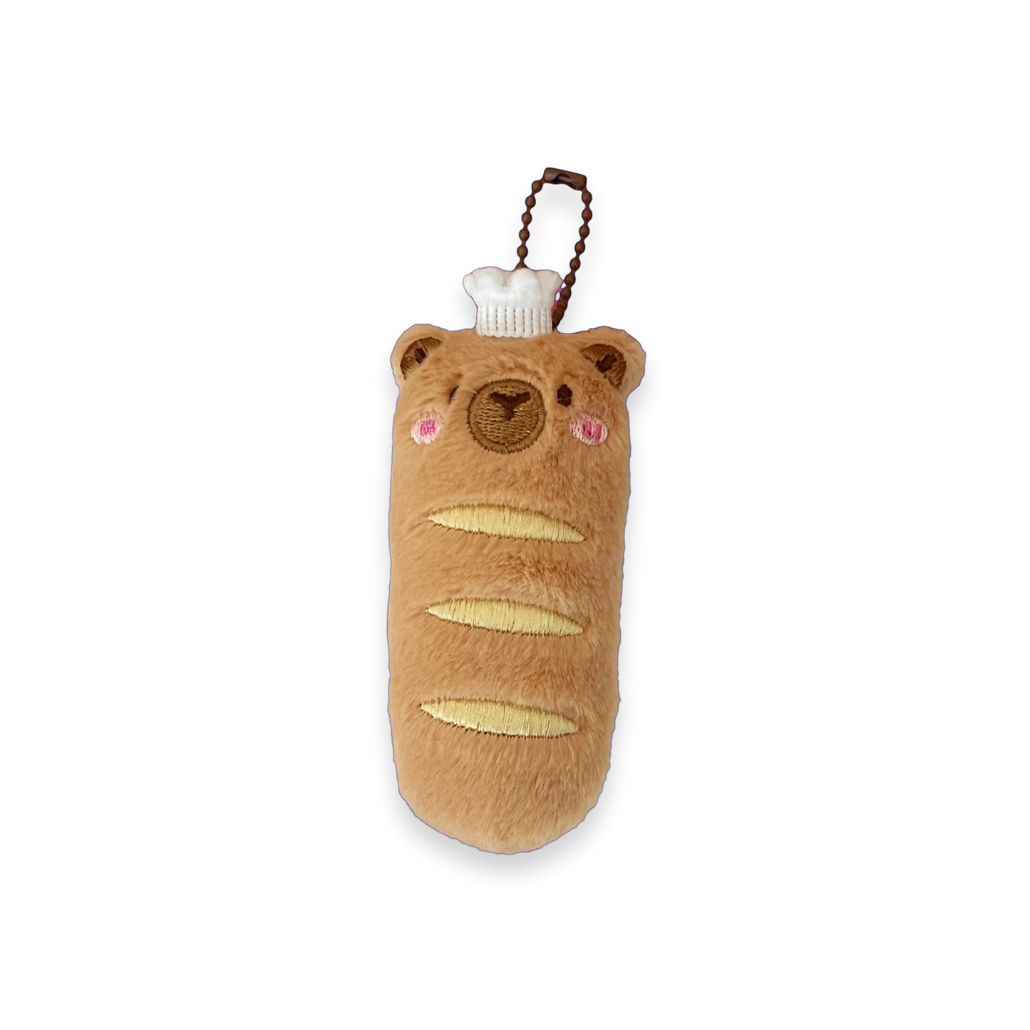 A plush keychain shaped like a cute brown baguette with embroidered details, pink cheeks, and a small white chef hat, attached to a brown braided strap on a white background.