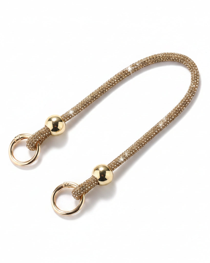 A clear mobile phone case with a luxury rhinestone lanyard attached to it, featuring a sparkling strap and rhinestone clasps.