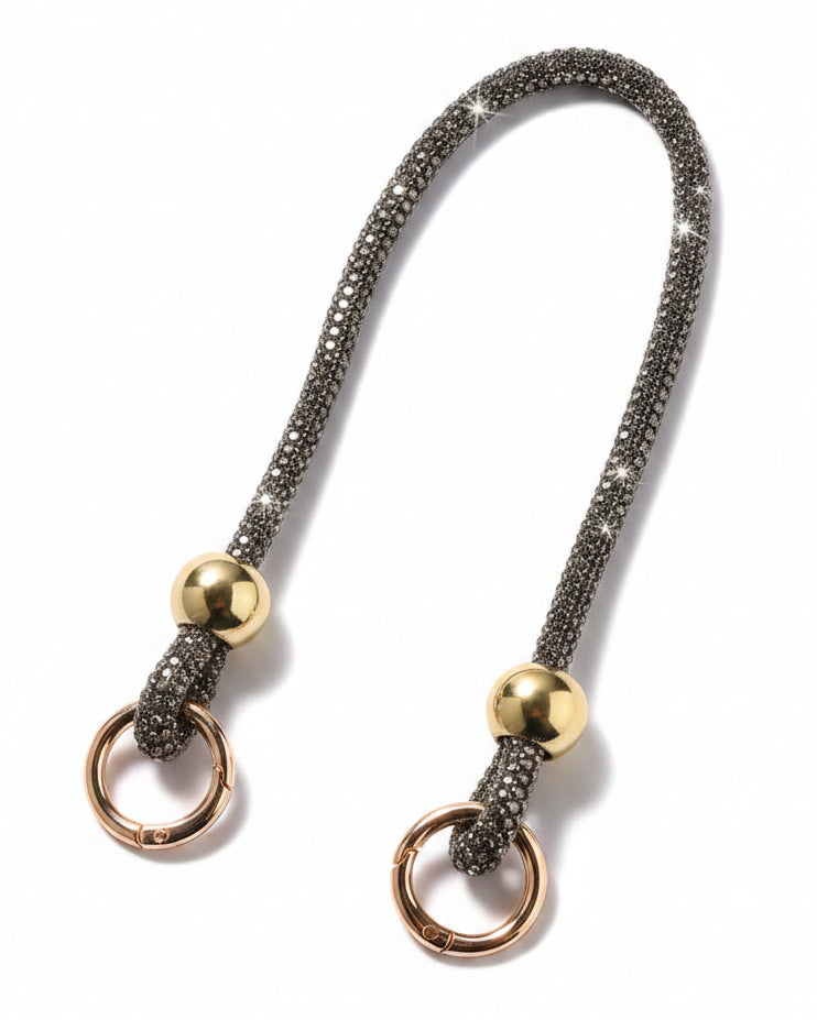 A clear mobile phone case with a luxury rhinestone lanyard attached to it, featuring a sparkling strap and rhinestone clasps.