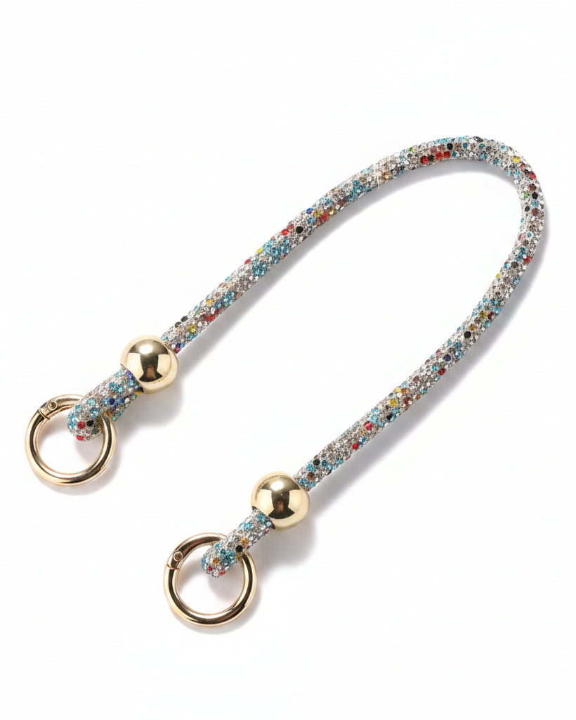 Multicolored beaded keychain with gold rings on a light surface