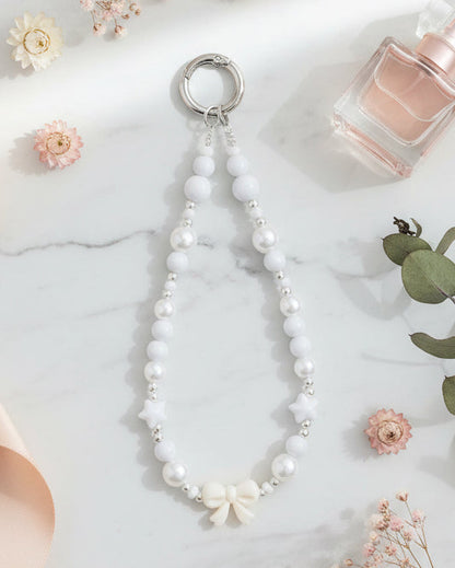 White pearl beaded phone charm wristlet with bow charm