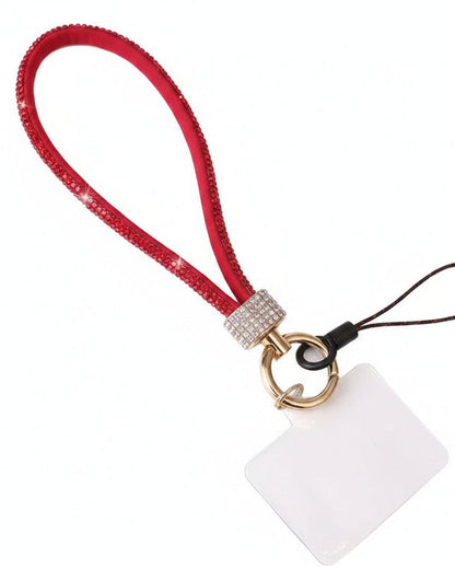 Red lanyard with a decorative charm on a textured surface