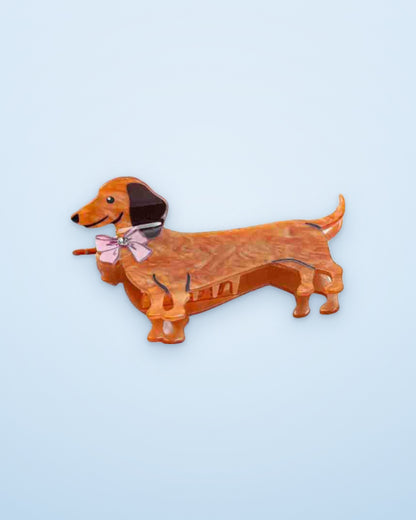 Pink Bow Doxie dachshund claw clip on a sky blue background