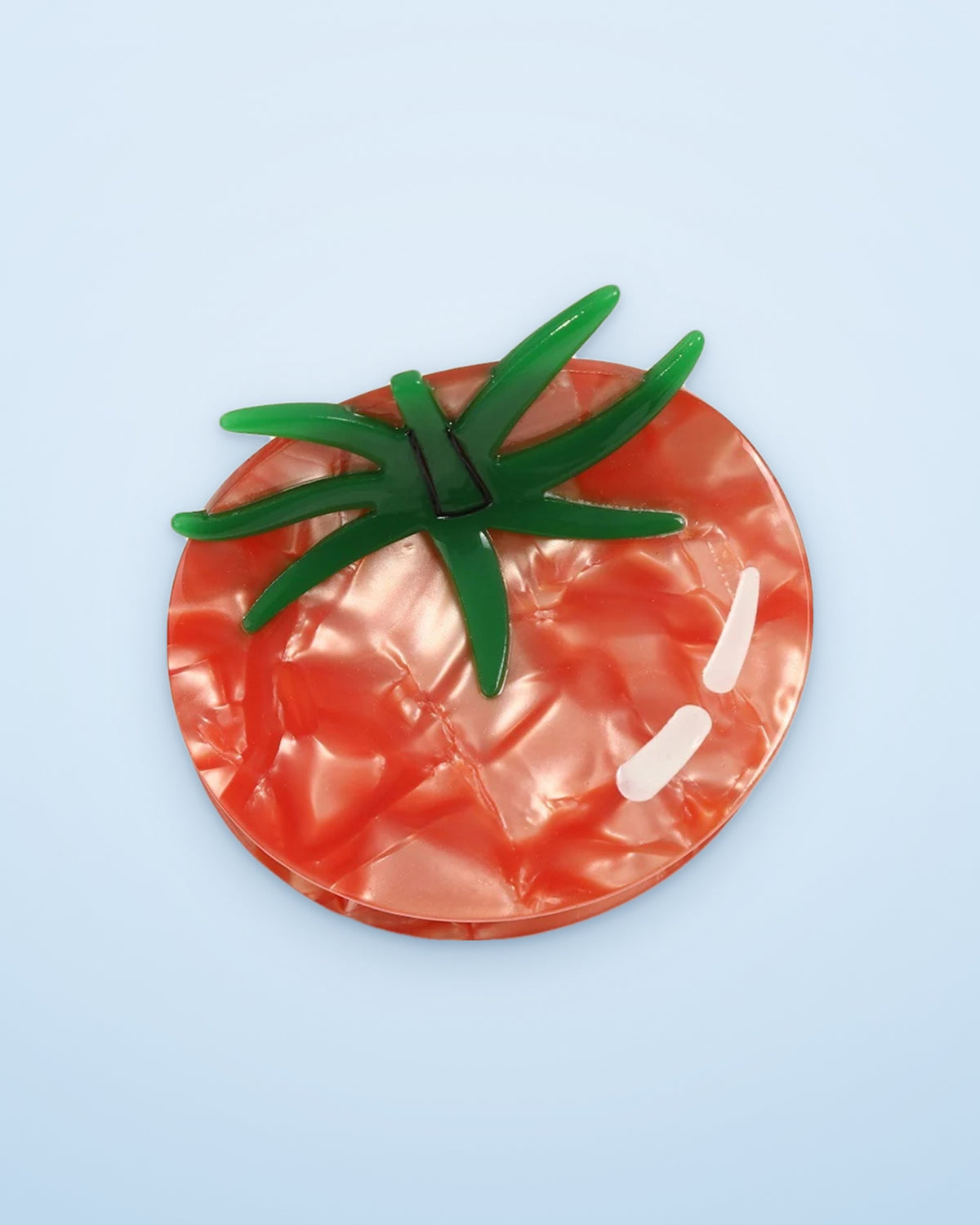 Marbled tomato acetate claw clip on a sky blue background