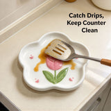 Tulip ceramic spoon rest catching drips from a spatula