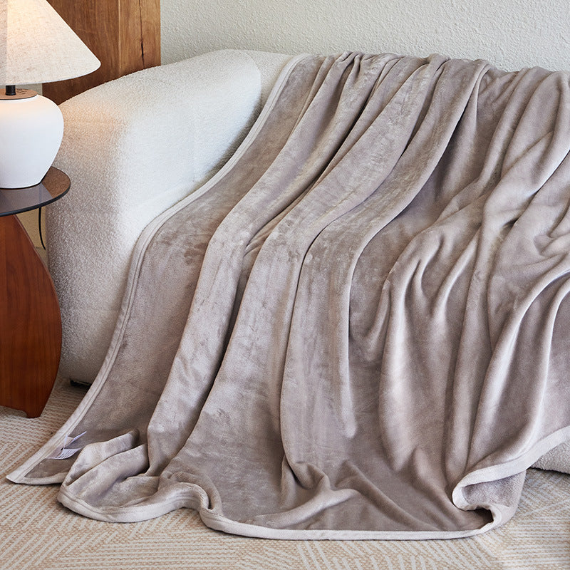 Flannel fleece blanket draped over a sofa