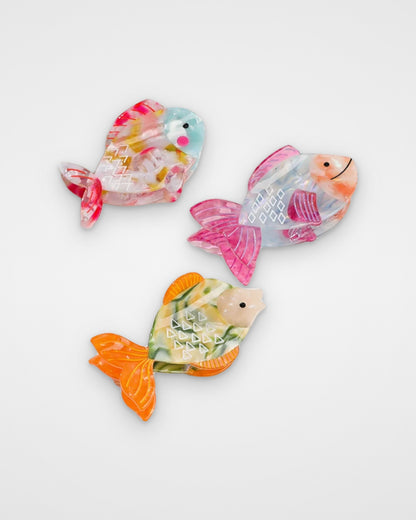 Confetti Fish, Pink Fin Fish and Orange Tail Fish acetate claw clips on a light gray background