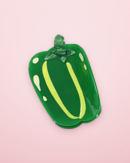 Green pepper acetate claw clip on a blush pink background