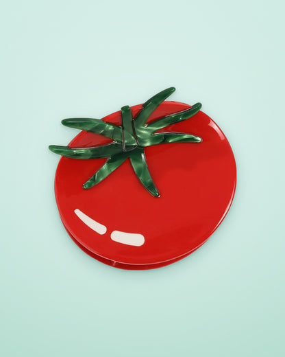 Tomato acetate claw clip on a seafoam background