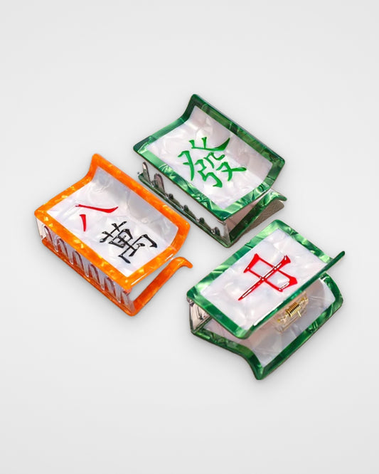 Mahjong tile acetate claw clips — Eight Characters, Green Dragon and Red Dragon on a light gray background
