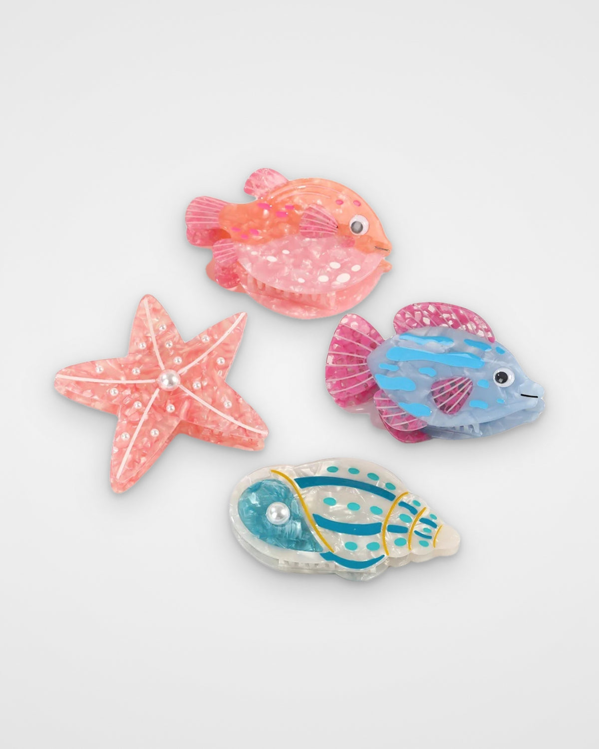 Reef life acetate claw clips — Coral Pufferfish, Pearl Starfish, Blue Lagoon Fish and Seafoam Conch on a light gray background