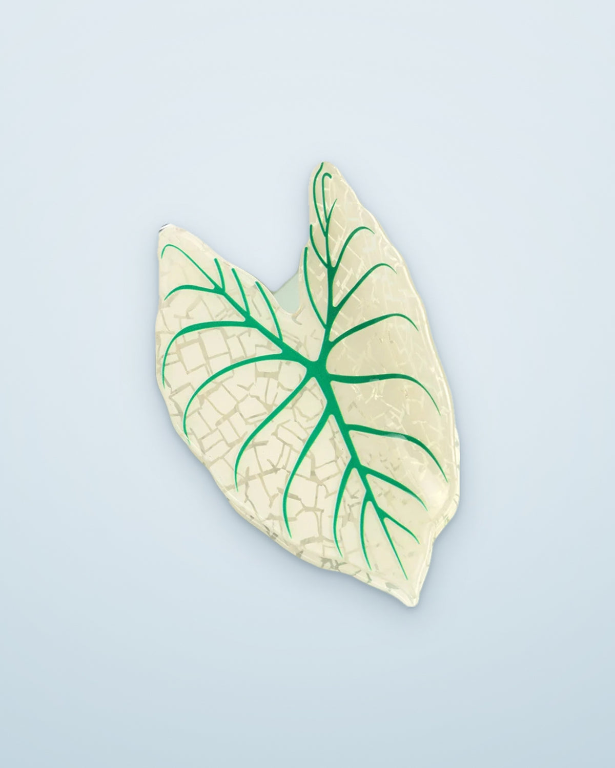Ivory Lace leaf claw clip on a dusty blue background