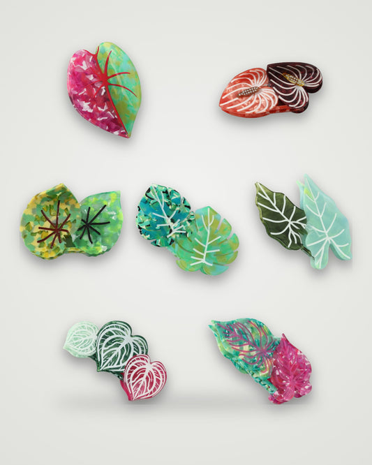 Botanical leaf acetate claw clips in all seven designs on a light gray backdrop