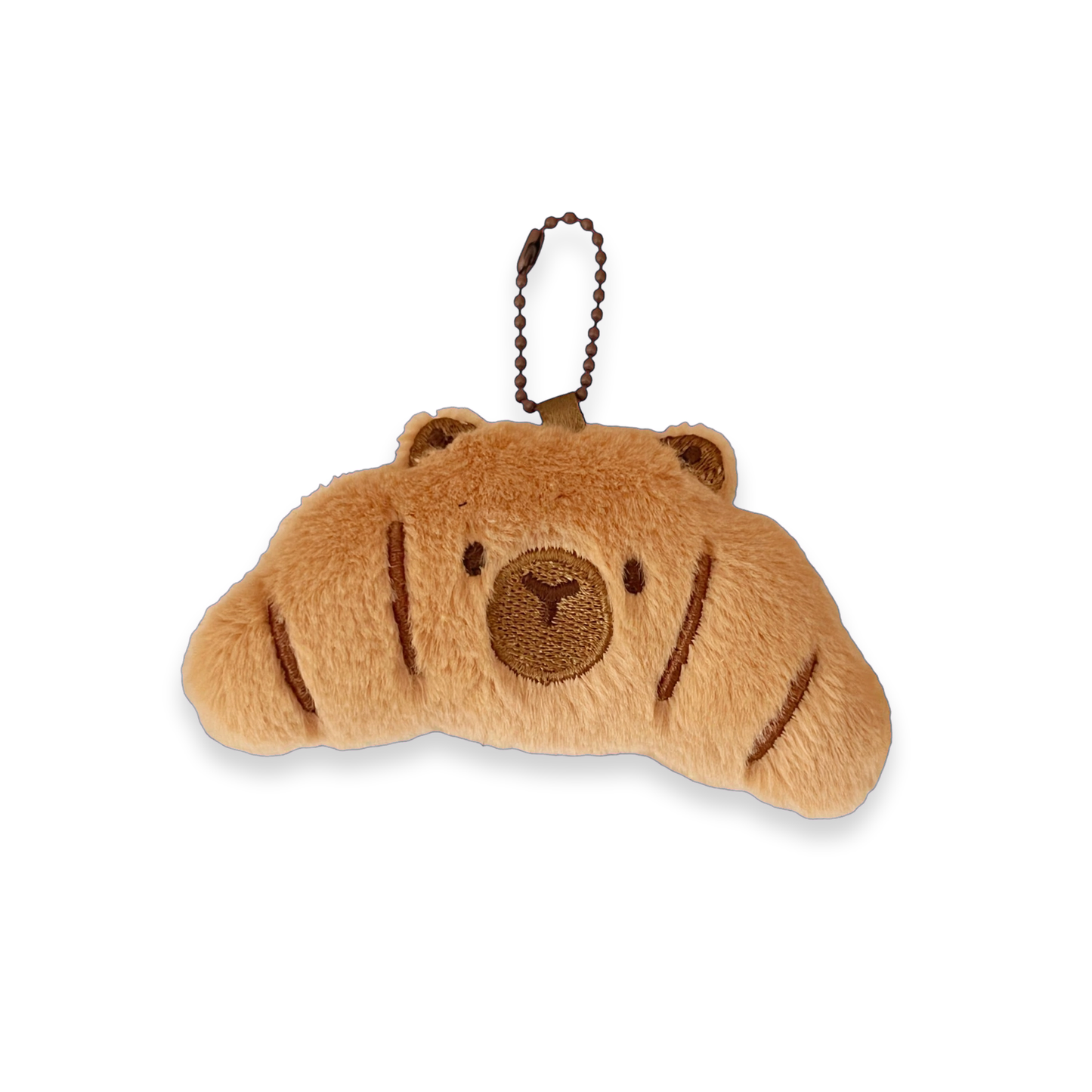 A plush croissant-shaped keychain charm in light brown with darker brown embroidered facial features and stripes, attached to a dark brown beaded keychain loop, shown on a plain white background.