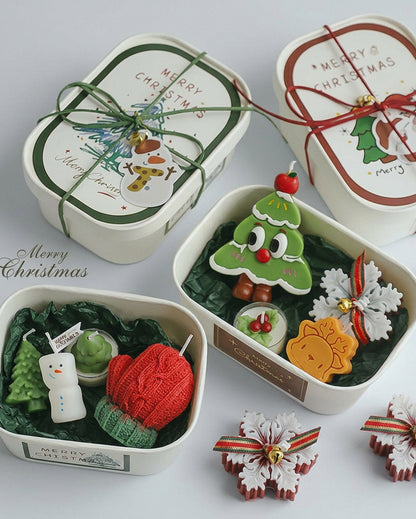Open Christmas candle gift box with Christmas tree, snowflake and reindeer candles