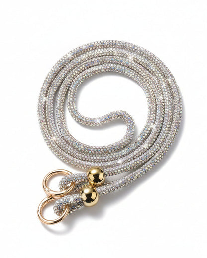 A clear mobile phone case with a luxury rhinestone lanyard attached to it, featuring a sparkling strap and rhinestone clasps.