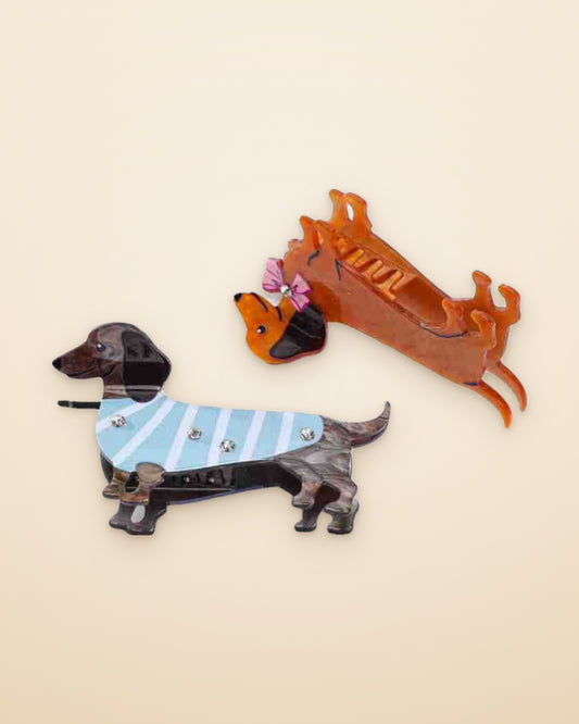Pink Bow Doxie claw clip shown open beside the Sweater Weather Doxie on a sand background
