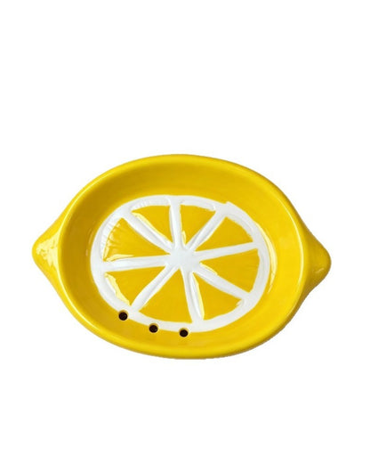 Lemon soap dish showing drainage holes on white background