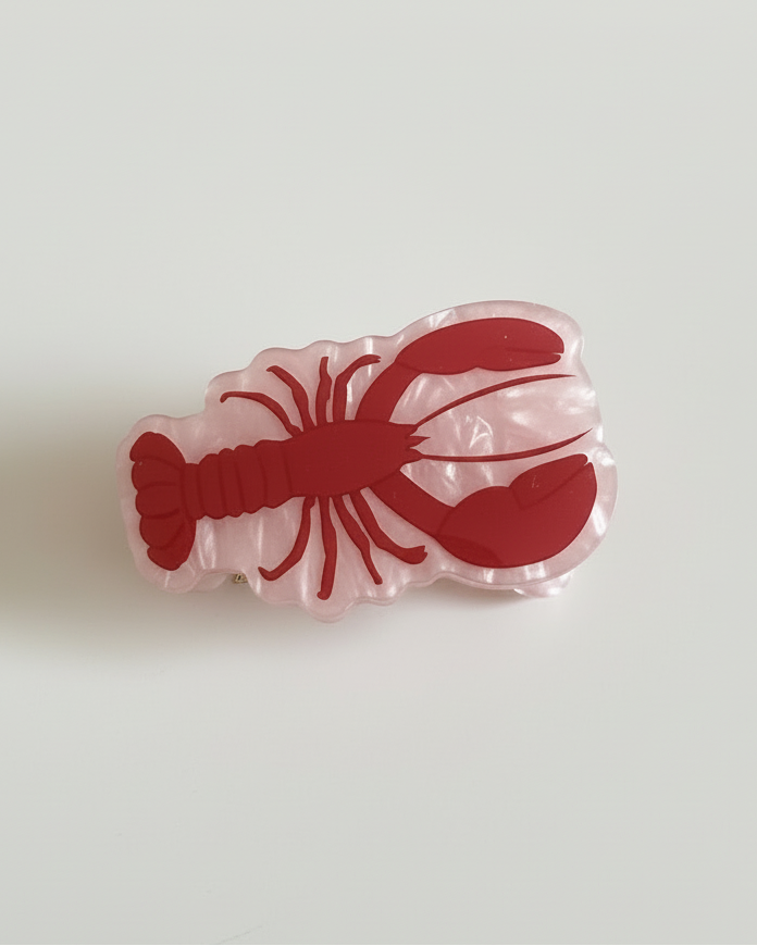 Lobster-shaped acrylic hair clip on a clean white background