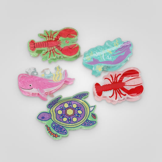 Ocean creatures acetate claw clips — lobster, mermaid, whale and sea turtle designs on a light gray background